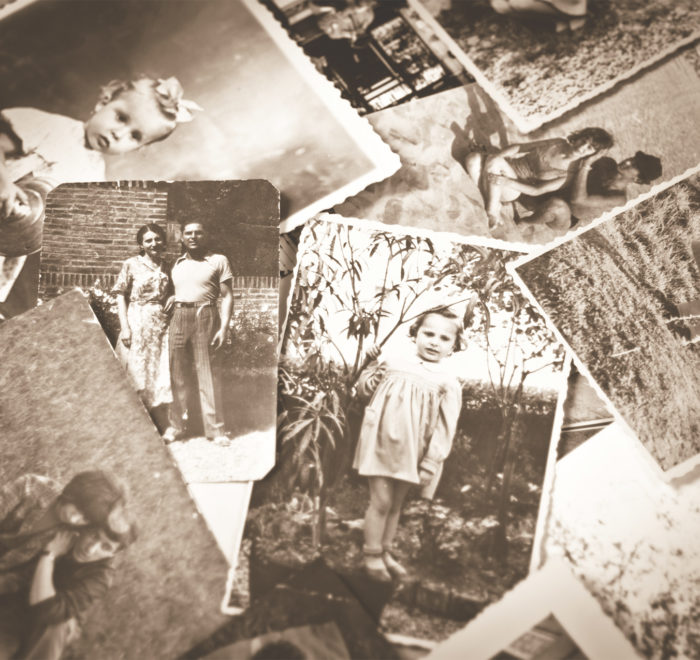 Sepia image of a pile of old photographs.